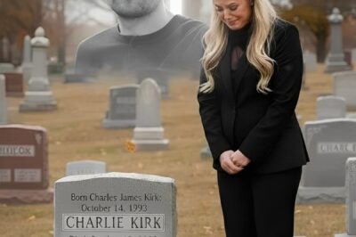 The wind howled through the cemetery like a warning as Erika Kirk dropped to her knees beside the cold stone that bore her husband’s name. Her fingertips traced every letter carved into the granite — the name the world thought belonged to a man who’d simply died.